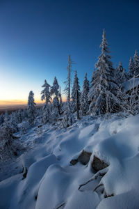 Scenic view of frozen landscape against clear blue sky