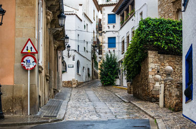 Street amidst buildings in city, sitges. 