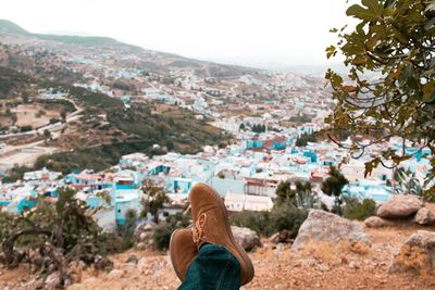 Rear view of person looking at city buildings