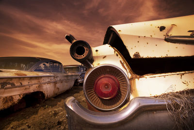 Abandoned airplane on runway against sky during sunset