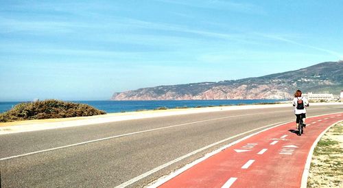 Man on road against sky