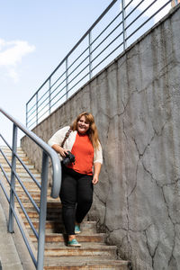 Portrait of young woman on staircase