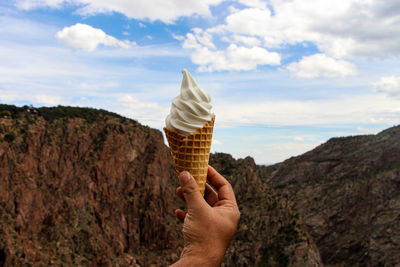 Human hand holding ice cream cone
