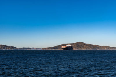 Scenic view of sea against clear blue sky