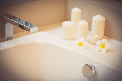 Close-up of illuminated candles on table
