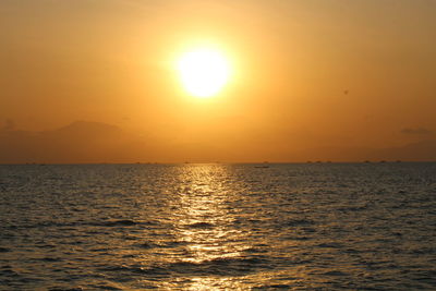 Scenic view of sea against orange sky