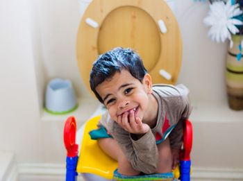 Boy sitting on toilet