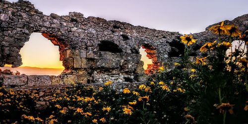 Scenic view of rocks against sky during sunset