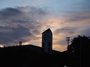Low angle view of silhouette building against sky at sunset
