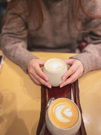 Midsection of woman holding coffee