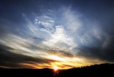 Low angle view of silhouette landscape against sky during sunset