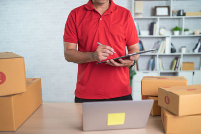 Midsection of man holding box