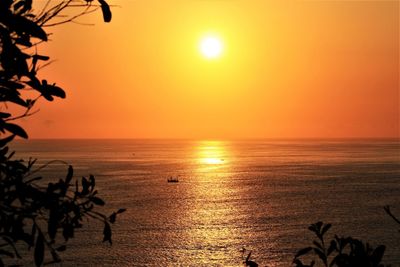 Scenic view of sea against orange sky