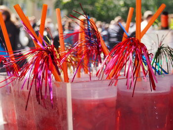 Close-up of drinks with decorative straws at carnival