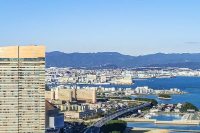 High angle view of city buildings against clear sky