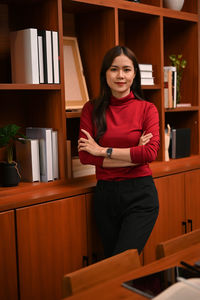 Portrait of young woman sitting on table