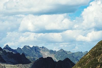 Scenic view of mountains against cloudy sky