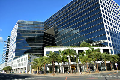 Low angle view of modern building against blue sky