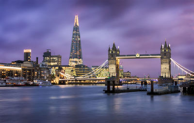 View of suspension bridge in city at night