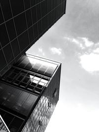 Low angle view of modern building against cloudy sky