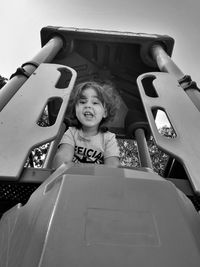 Child smiling down from playhouse