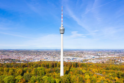 View of communications tower in city against sky