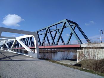 Low angle view of bridge against blue sky