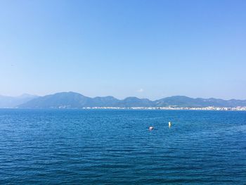 Scenic view of sea against clear blue sky