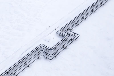 High angle view of pipeline on snow covered field