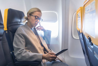 Full length of man sitting in train