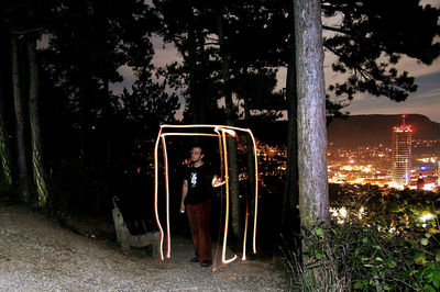 Telephone booth against sky at night