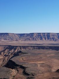 Scenic view of dramatic landscape against clear blue sky