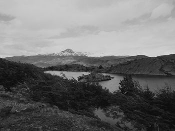 Scenic view of lake and mountains against sky