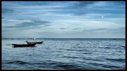 Scenic view of sea against cloudy sky