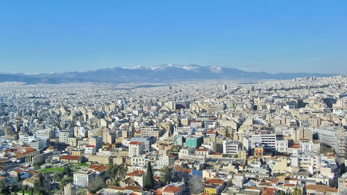 High angle view of townscape against blue sky