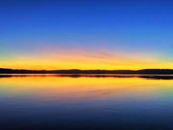 Scenic view of lake against romantic sky at sunset