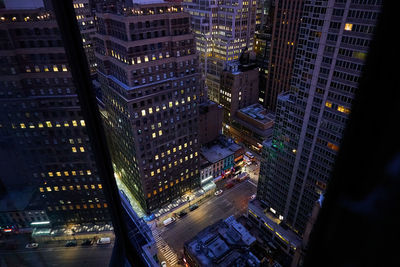 High angle view of illuminated city street at night