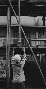 Rear view of boy standing in front of building