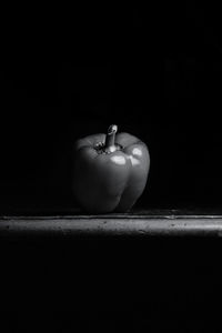 Close-up of apple on table against black background