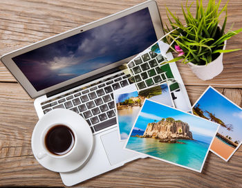 Directly above shot of laptop and book and mobile phone on table