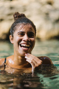 Smiling young woman in sea