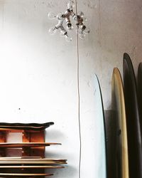 Surfboards and skateboards against wall at store for sale