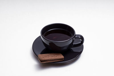 High angle view of coffee cup against white background