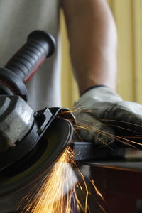 Cropped hand of man holding equipment