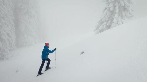 Man skiing on snow covered mountain