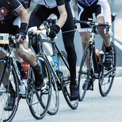 Low section of people riding bicycle on road