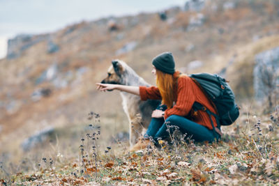 Side view of man sitting on land