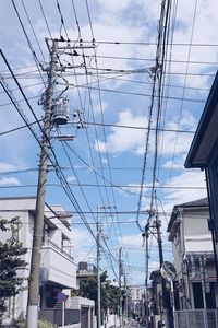 Low angle view of electricity pylon against sky