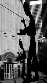 Full length of young woman playing with arms raised