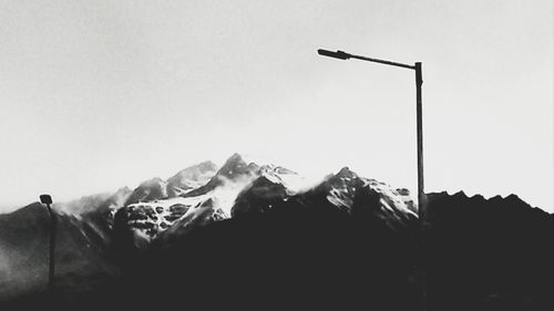 Low angle view of silhouette mountains against clear sky